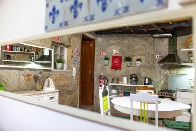a kitchen with a stone wall at Red House- Historic center in Porto