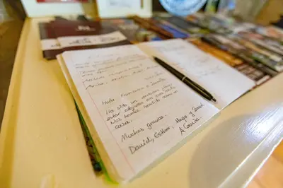a notebook with writing on it on a counter with pens at Red House- Historic center in Porto