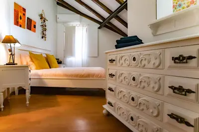 a bedroom with a bed and a dresser at Red House- Historic center in Porto