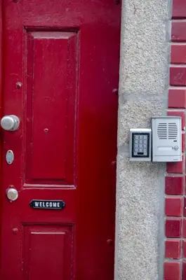 a red door with a box next to it at Red House- Historic center in Porto