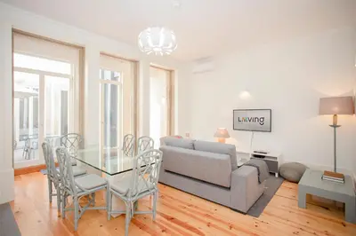 a white kitchen with a glass table and chairs at Liiiving in Porto | Central Secret Terrace in Porto