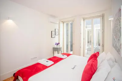 a bedroom with two beds and a window at Liiiving in Porto | Central Secret Terrace in Porto