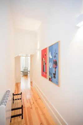 a living room with two paintings on the wall at Liiiving in Porto | Central Secret Terrace in Porto