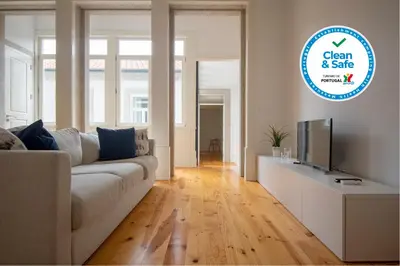 a living room with a white couch and a tv at Porto Ildefonso II in Porto