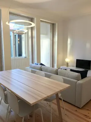 a living room with a table and a couch at Porto Ildefonso II in Porto