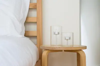 a nightstand with two glasses on it next to a bed at Porto Ildefonso II in Porto