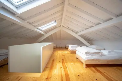 a attic room with two beds and a skylight at Porto Ildefonso II in Porto