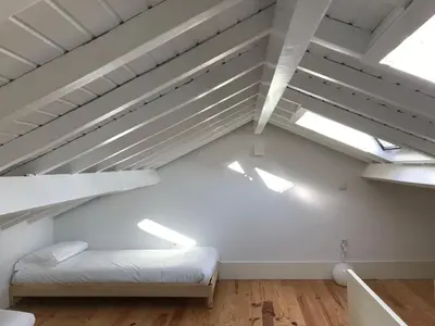an attic room with a bed and skylights at Porto Ildefonso II in Porto