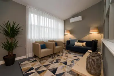 a living room with a couch and chairs and a table at De Porto e Alma in Porto
