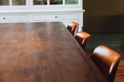 a wooden table with two chairs and a white dresser at VIVA 4 Suites Batalha Residence & SIZE Flats Batalha in Porto