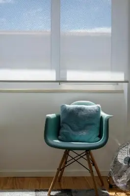 a green chair sitting in front of a window at LAZ apartment in Porto