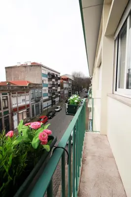 a balcony of a building with pink flowers on it at LAZ apartment in Porto