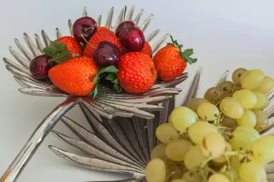 a bottle of wine and a plate of strawberries on a table at Oporto Platinum Loft in Porto