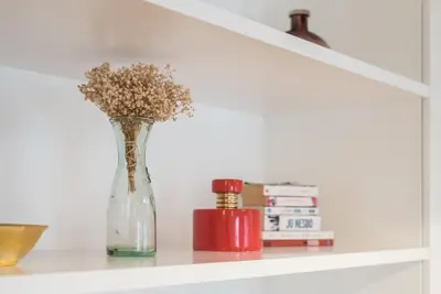 a vase with flowers in it sitting on a shelf at GuestReady - Chic city nest in Porto in Porto