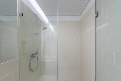 a shower with a glass door in a bathroom at GuestReady - Chic city nest in Porto in Porto