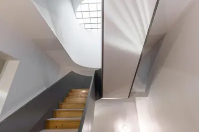 a spiral staircase with a metal railing in a house at Domus 21 - Formosa in Porto
