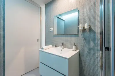 a bathroom with a sink and a mirror at GuestReady - Crayon Walls Apartments in Porto