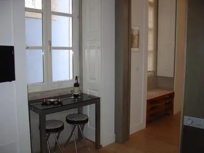 a room with a table and two stools and a window at Downtown Historical Apartment in Porto