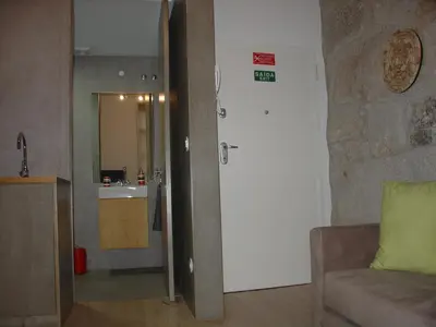 a living room with a couch and a kitchen at Downtown Historical Apartment in Porto