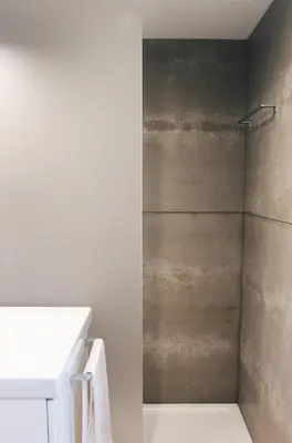 a shower stall in a bathroom with a white sink at Lost Apartments in Porto