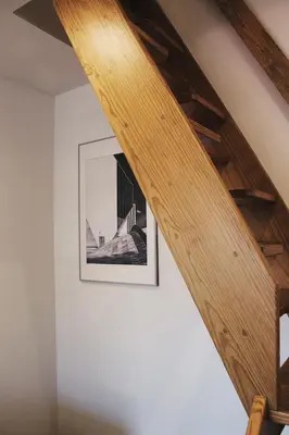 a wooden staircase in a room with a picture on the wall at Lost Apartments in Porto