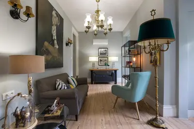 a living room with a couch and a chair at the gallery Studios II in Porto