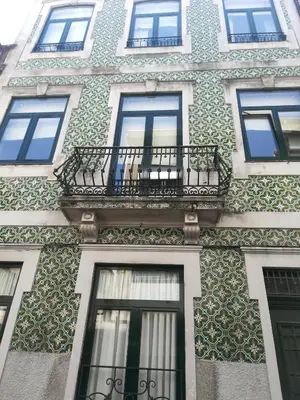 a building with a balcony on the side of it at the gallery Studios II in Porto