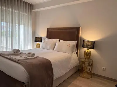 a bedroom with a large bed with a large window at ML Apartments Avenue in Porto