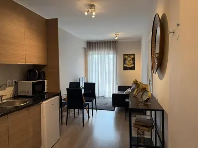 a kitchen and living room with a table and a living room at ML Apartments Avenue in Porto