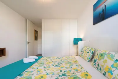 a white room with a bed and a couch at Apartamento Qian Caves Gaia 2BR AC Free Parking in Vila Nova de Gaia