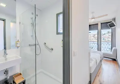 a bathroom with a shower and a sink at Oporto Street Fonte Taurina - Riverfront Suites in Porto