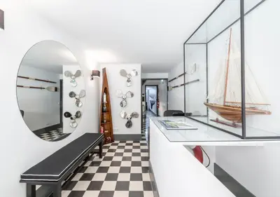a room with a mirror and a black bench at Oporto Street Fonte Taurina - Riverfront Suites in Porto