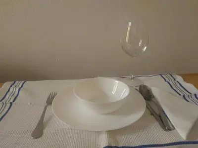 a white bowl on a table with a wine glass at Flower's Downtown Porto in Porto