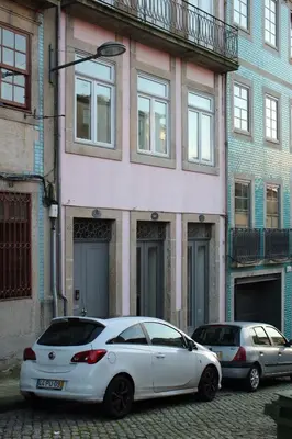 a white car parked in front of a building at Flower's Downtown Porto in Porto