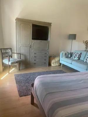 a glass table with four chairs and a lamp at Flats 323 apartments in Porto