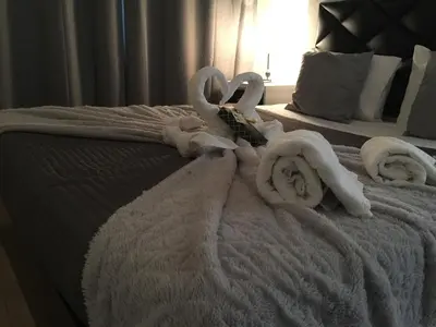 a bed with towels on top of it at Invicta house Boavista in Porto