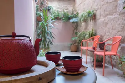 a tea pot and cups sitting on a table at HOMEinTOWN Almada - Downtown Elegant Apartment - Terrace AC & WIFI in Porto