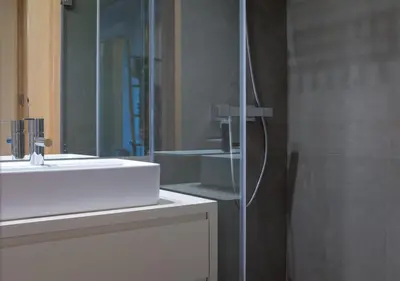 a bathroom with a sink and a shower with a mirror at HOMEinTOWN Almada - Downtown Elegant Apartment - Terrace AC & WIFI in Porto