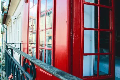 a red phone booth on the side of a building at Hannah's Studios in Porto