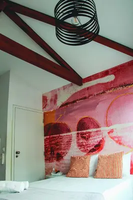 a bedroom with a red painted wall with a bed at Hannah's Studios in Porto