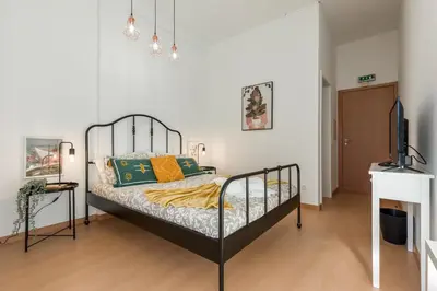 a bedroom with a bed and a television in it at Oporto Bonjardim Residence in Porto