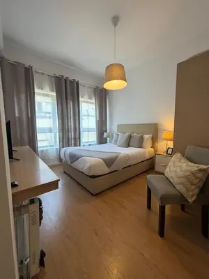 a bedroom with a bed and a chair in it at Oporto Bonjardim Residence in Porto