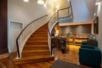 a staircase in an office with a stair case at Santa Catarina FLH Suites in Porto
