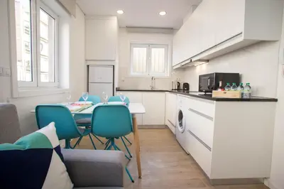 a kitchen with a table and chairs in a room at Camões 691 Design Apartments by Porto City Hosts in Porto