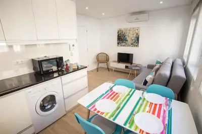 a kitchen and living room with a table and a couch at Camões 691 Design Apartments by Porto City Hosts in Porto