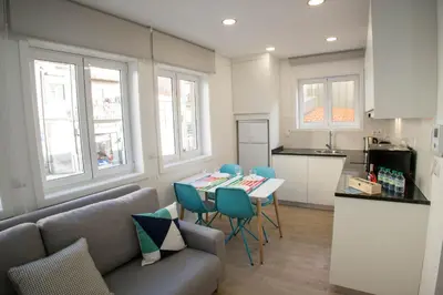 a kitchen with a couch and a table and chairs at Camões 691 Design Apartments by Porto City Hosts in Porto