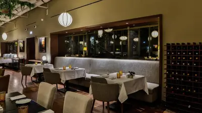 a restaurant with white tables and chairs and lights at InterContinental Porto - Palacio das Cardosas by IHG in Porto