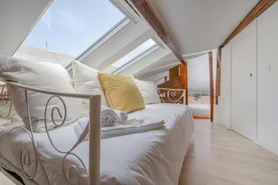 a bedroom with a white bed with a window at BestVillas Casa do Rio in Vila Nova de Gaia