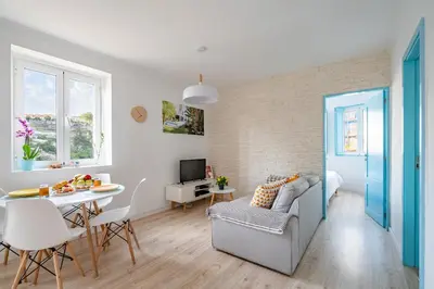 a living room with a table and a dining room at BestVillas Casa do Rio in Vila Nova de Gaia