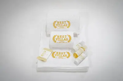 a pile of white towels with the words best whiskas at BestVillas Casa do Rio in Vila Nova de Gaia